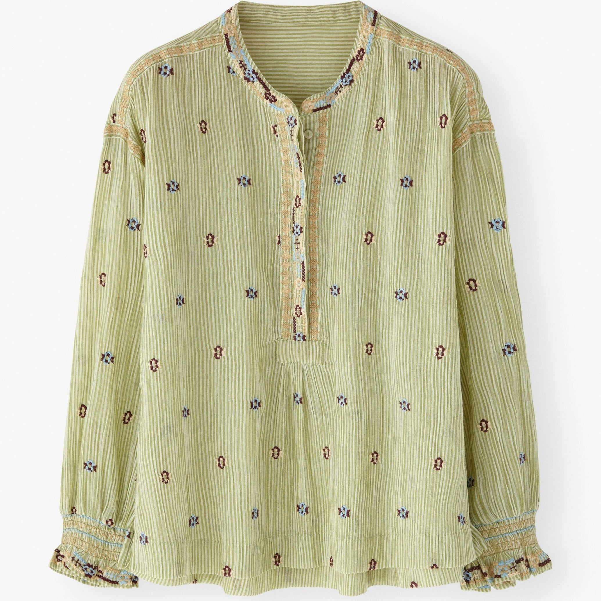 Green patterned blouse on a white background