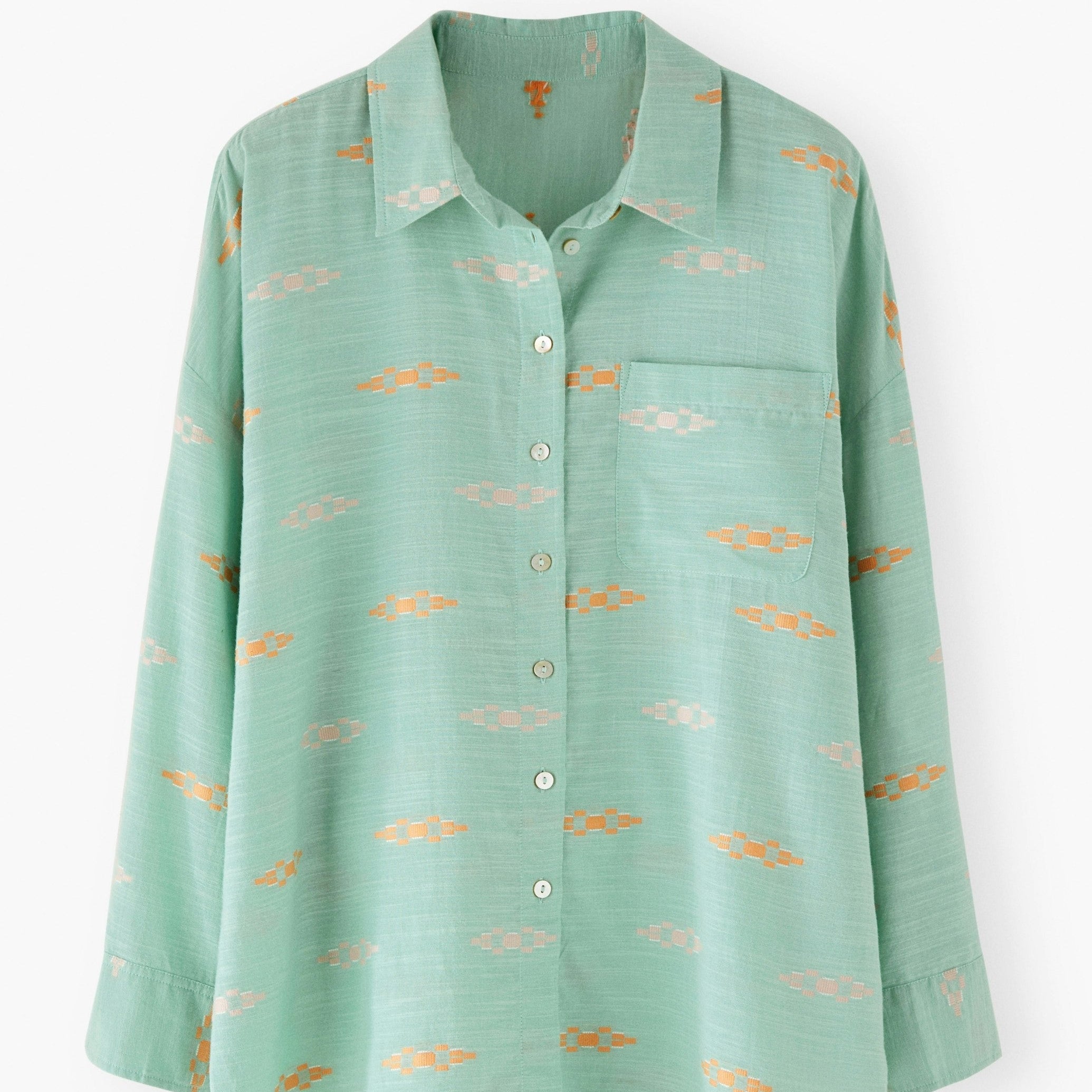 Green shirt with small patterns on a white background