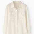 Beige button-up shirt on a white background